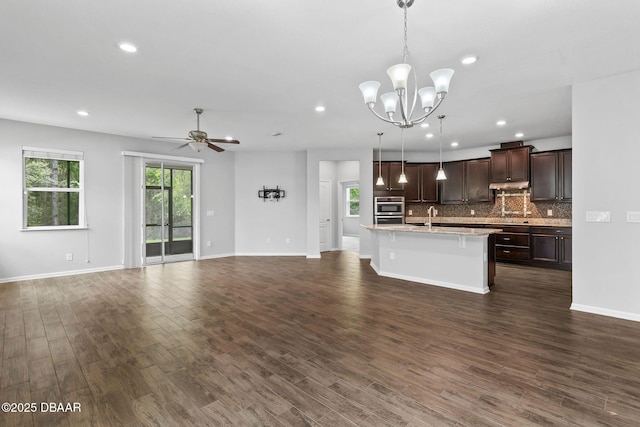 115 Pergola Pl, Ormond Beach, FL 32174 - kitchen featuring open floor plan, double oven, dark brown cabinets, light countertops, and a kitchen breakfast bar