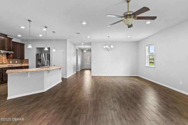 115 Pergola Pl, Ormond Beach, FL 32174 - kitchen featuring stainless steel fridge with ice dispenser, under cabinet range hood, dark wood finished floors, a ceiling fan, and a breakfast bar area