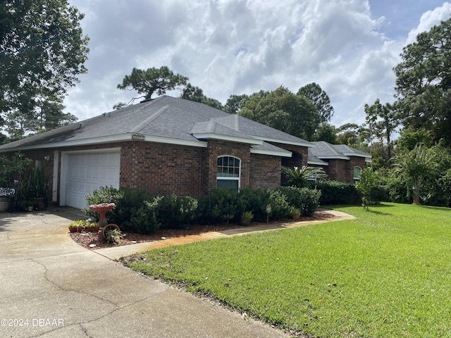 view of front of property with a front yard and a garage