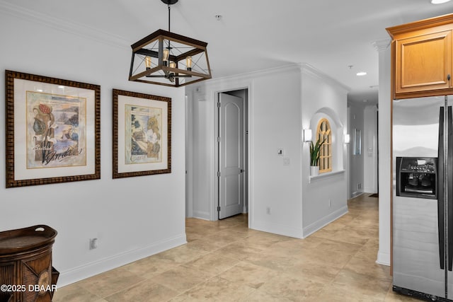 interior space with crown molding, recessed lighting, baseboards, and a chandelier