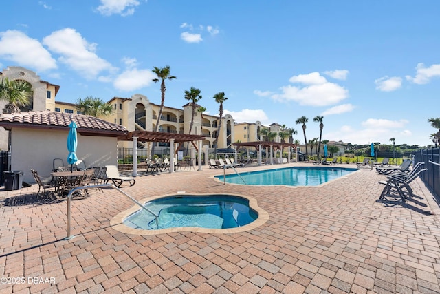 community pool with fence, a pergola, a patio, a hot tub, and a residential view