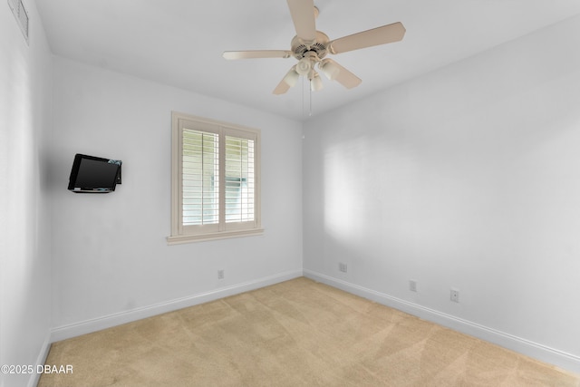 unfurnished room with baseboards, ceiling fan, carpet flooring, and visible vents