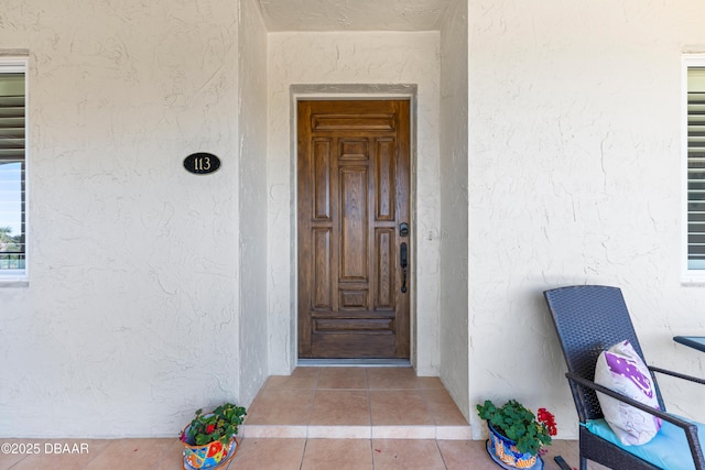 doorway to property with stucco siding
