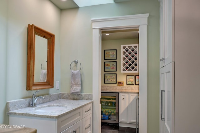 bathroom featuring tile patterned floors, vanity, and wine cooler