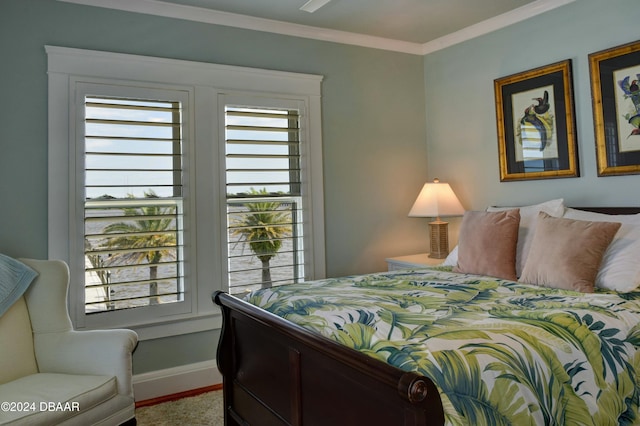 bedroom with wood-type flooring, ornamental molding, and multiple windows