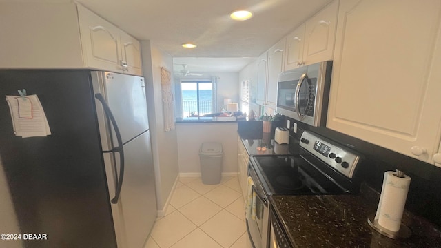 kitchen with white cabinetry, light tile patterned floors, and appliances with stainless steel finishes