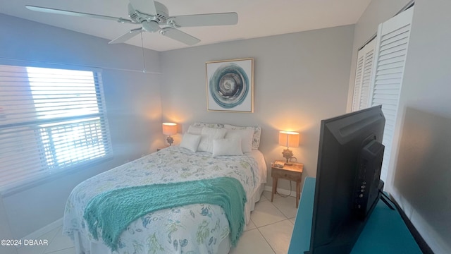 bedroom with ceiling fan and light tile patterned floors