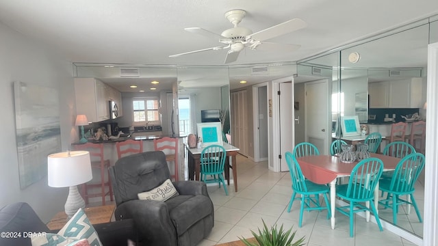 tiled dining space featuring ceiling fan