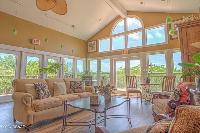 living room with high vaulted ceiling and plenty of natural light