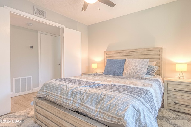 bedroom with light hardwood / wood-style floors and ceiling fan