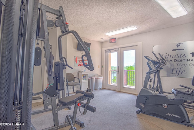 exercise area featuring a textured ceiling