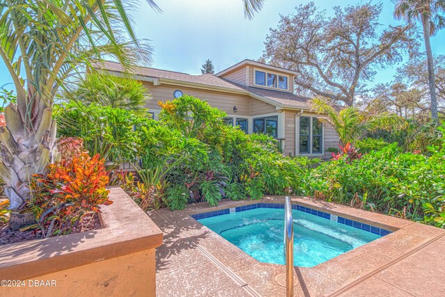 view of pool with an in ground hot tub