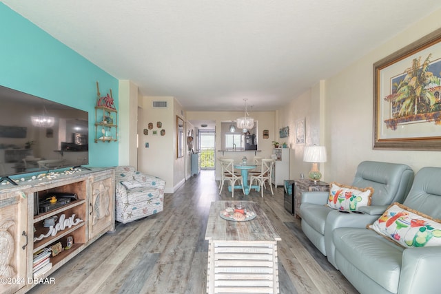 living room featuring hardwood / wood-style floors and an inviting chandelier