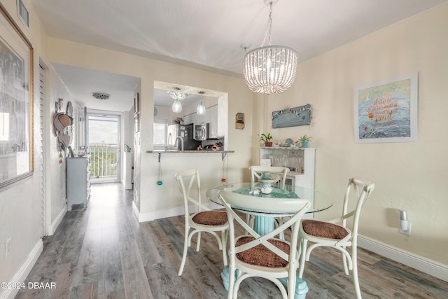 dining area featuring a chandelier and hardwood / wood-style floors