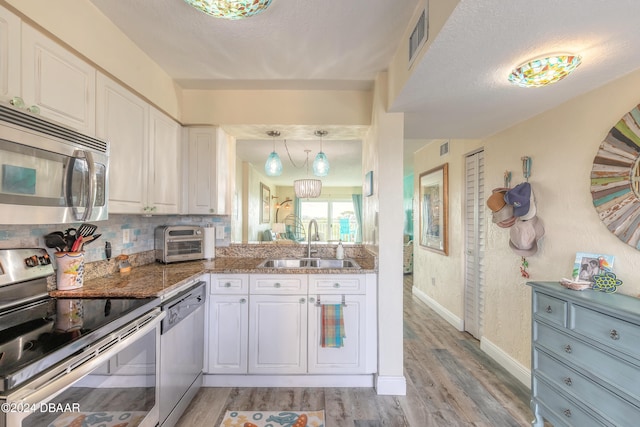 kitchen with sink, white cabinetry, and stainless steel appliances