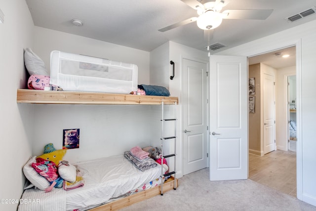 bedroom featuring light carpet, ceiling fan, and visible vents