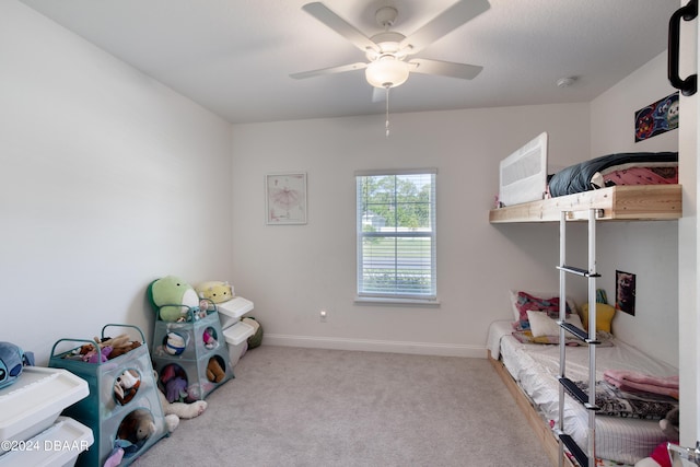 bedroom featuring baseboards, a ceiling fan, and light colored carpet