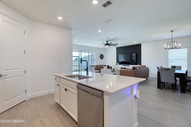 kitchen featuring visible vents, dishwasher, a kitchen island with sink, white cabinetry, and a sink