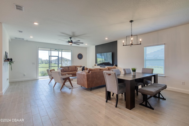 dining space featuring light wood-type flooring, visible vents, and recessed lighting