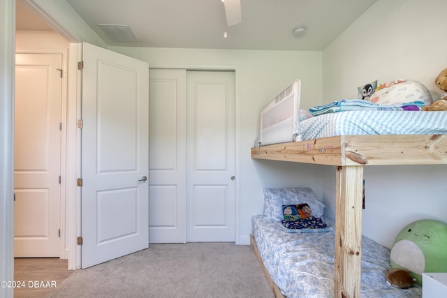 bedroom featuring light carpet, a closet, and visible vents