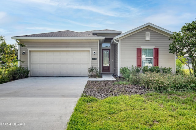 view of front of home featuring concrete driveway and an attached garage