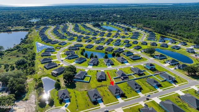 bird's eye view featuring a residential view and a water view