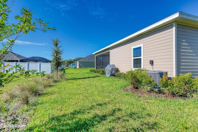 view of yard with a sunroom and fence