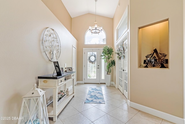 1405 Florida Moss Ln, Port Orange, FL 32128 - foyer entrance featuring a chandelier, high vaulted ceiling, and light tile patterned floors
