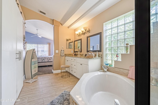 1405 Florida Moss Ln, Port Orange, FL 32128 - bathroom with lofted ceiling, double vanity, a garden tub, ceiling fan, and connected bathroom