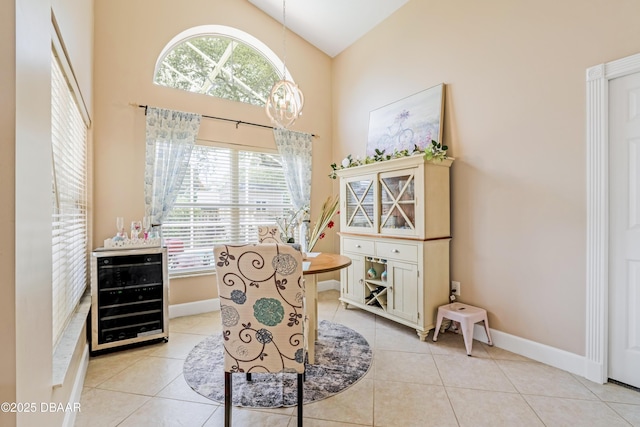 1405 Florida Moss Ln, Port Orange, FL 32128 - dining space featuring beverage cooler, high vaulted ceiling, and light tile patterned floors