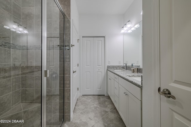 bathroom with walk in shower, tile patterned flooring, and vanity