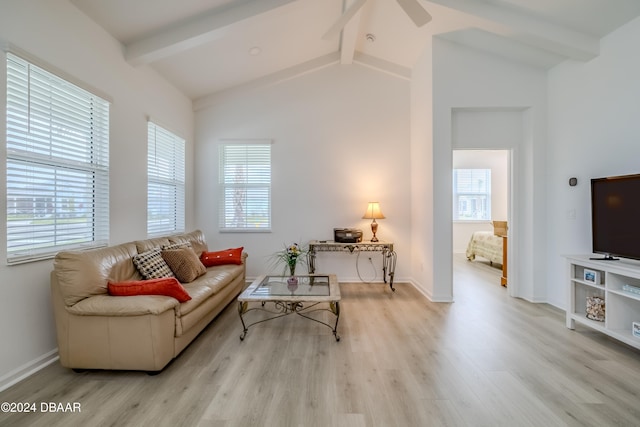 sitting room featuring light wood-type flooring, ceiling fan, and vaulted ceiling with beams