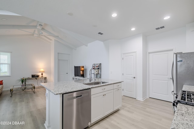 kitchen with stainless steel appliances, a center island with sink, vaulted ceiling with beams, white cabinets, and sink