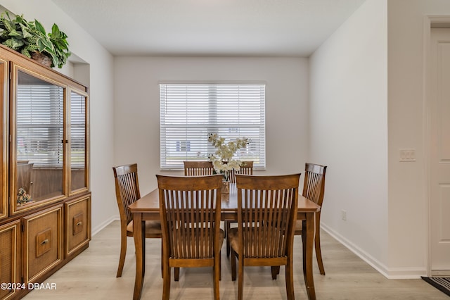 dining space with light hardwood / wood-style flooring