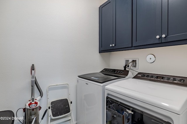 laundry room featuring cabinets and separate washer and dryer