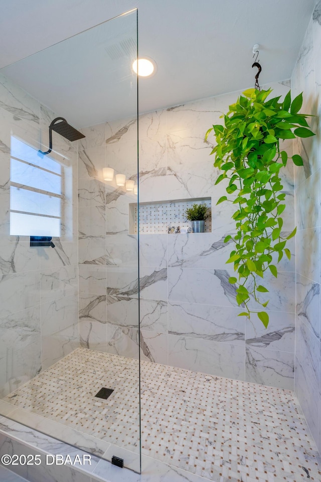 full bathroom with a marble finish shower