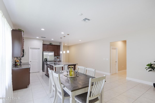 5567 Estero Loop, Port Orange, FL 32128 - dining area with light tile patterned floors, baseboards, recessed lighting, and visible vents