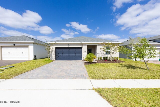 5567 Estero Loop, Port Orange, FL 32128 - ranch-style house featuring an attached garage, a front lawn, stucco siding, and driveway