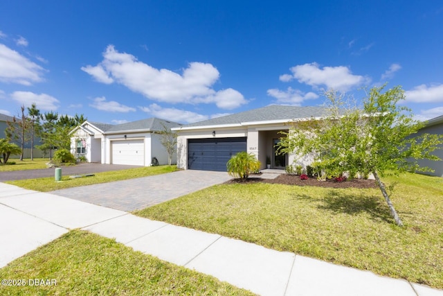 5567 Estero Loop, Port Orange, FL 32128 - ranch-style house featuring a garage, decorative driveway, stucco siding, and a front yard