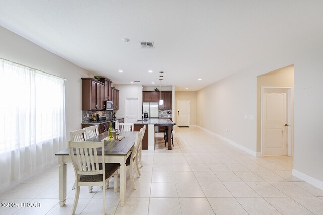 5567 Estero Loop, Port Orange, FL 32128 - dining room featuring recessed lighting, baseboards, visible vents, and light tile patterned floors
