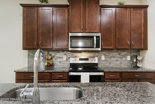5567 Estero Loop, Port Orange, FL 32128 - kitchen with a sink, appliances with stainless steel finishes, tasteful backsplash, and stone counters
