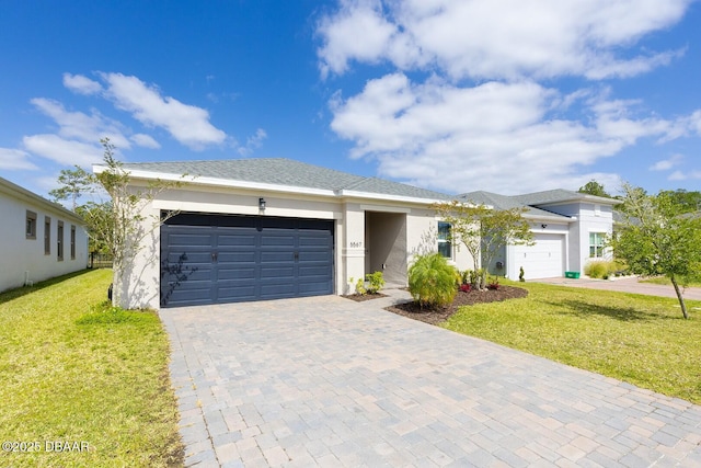 5567 Estero Loop, Port Orange, FL 32128 - view of front of home with stucco siding, decorative driveway, a front lawn, and a garage