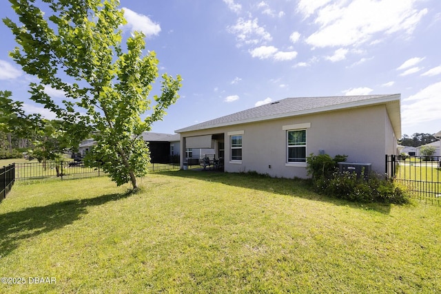 5567 Estero Loop, Port Orange, FL 32128 - rear view of house featuring a lawn, central AC unit, a fenced backyard, and stucco siding