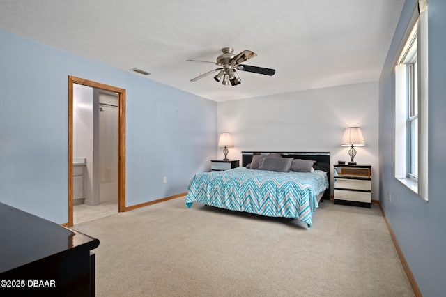 carpeted bedroom featuring connected bathroom and ceiling fan