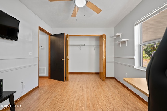 bedroom featuring light hardwood / wood-style flooring, a closet, and ceiling fan