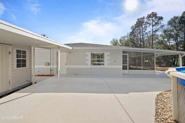 view of patio featuring a sunroom