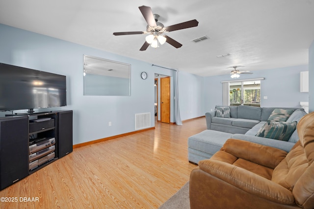 living room with hardwood / wood-style floors and ceiling fan