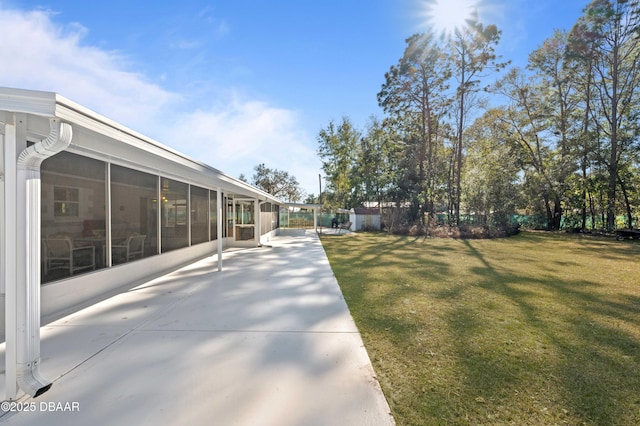 view of yard featuring a sunroom and a patio area