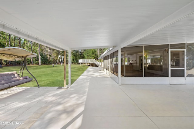 view of patio featuring a sunroom