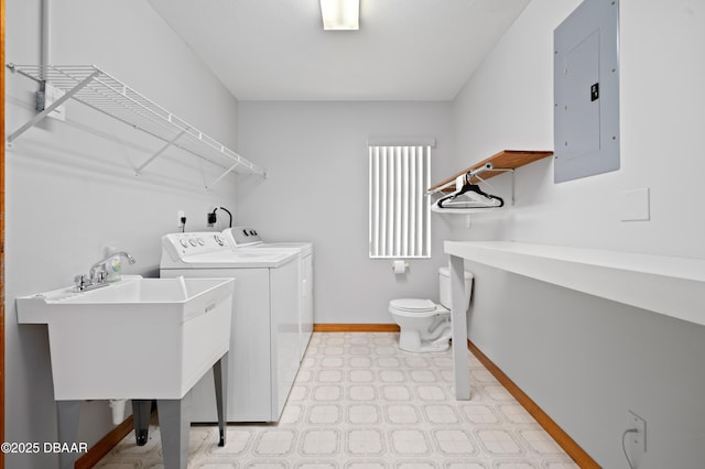 laundry room with sink, electric panel, and independent washer and dryer